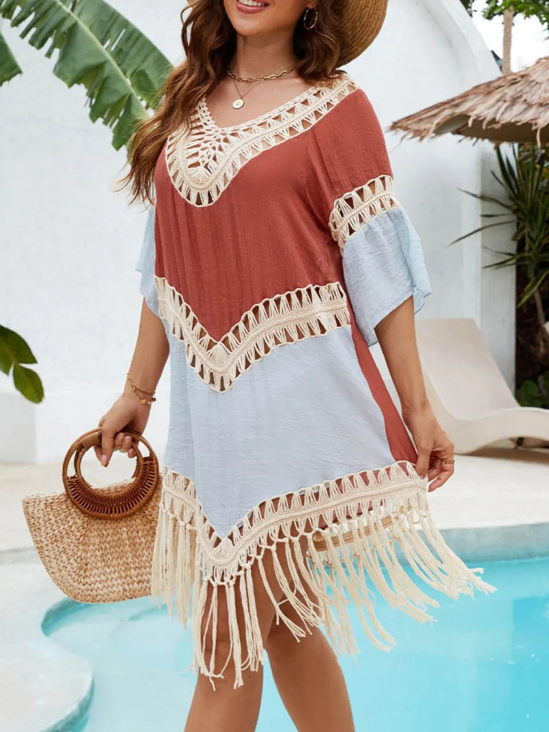 Women’s terracotta fringe beach cover-up layered over swimwear
