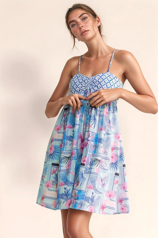 The Ibiza Geo Floral Tie-Back Romper in blue pink print
