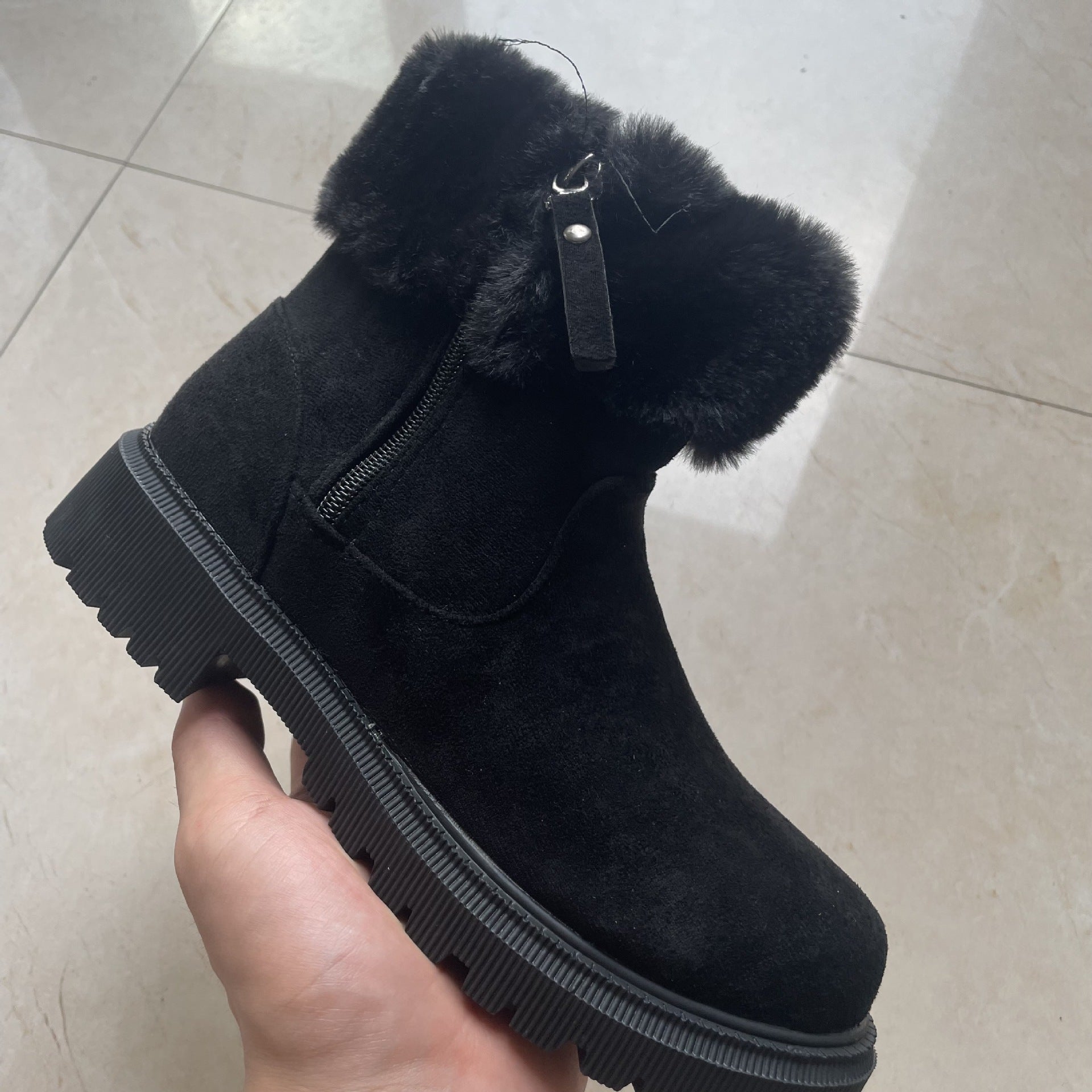 Black faux-fur cuff winter ankle boots styled for cold-weather outfits