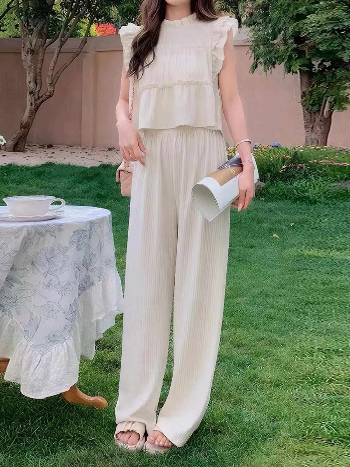 Women’s sleeveless ruffled top and wide-leg pants resort outfit