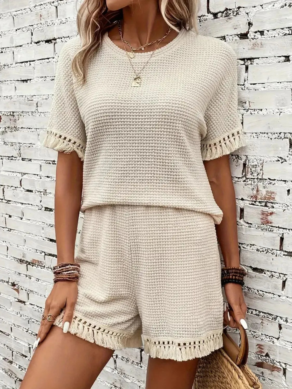 Cream tassel top and shorts lounge set styled for resort travel