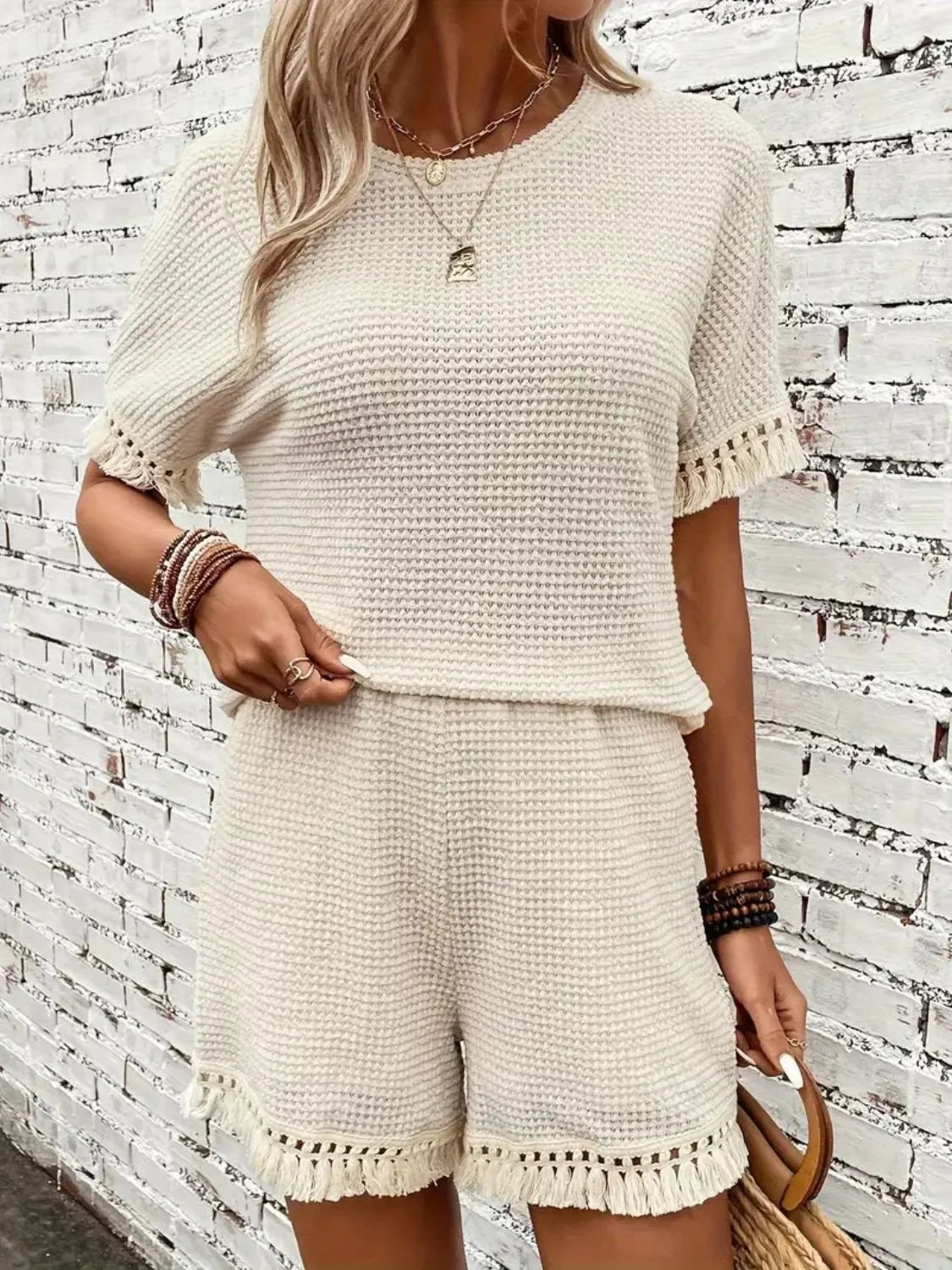 Cream tassel top and shorts lounge set styled for resort travel