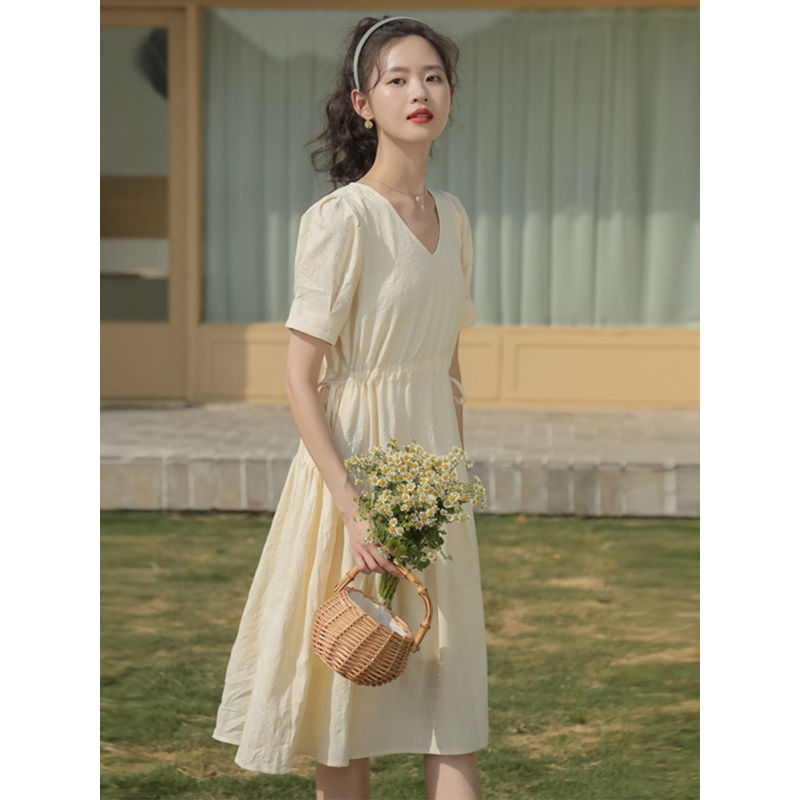 Petite Girls French Tea Break dress features a V-neck, drawstring-style neckline, elastic waist, commuting and office-style skirt silhouette, short sleeve, pleated midi-length skirt, solid-colored pattern,