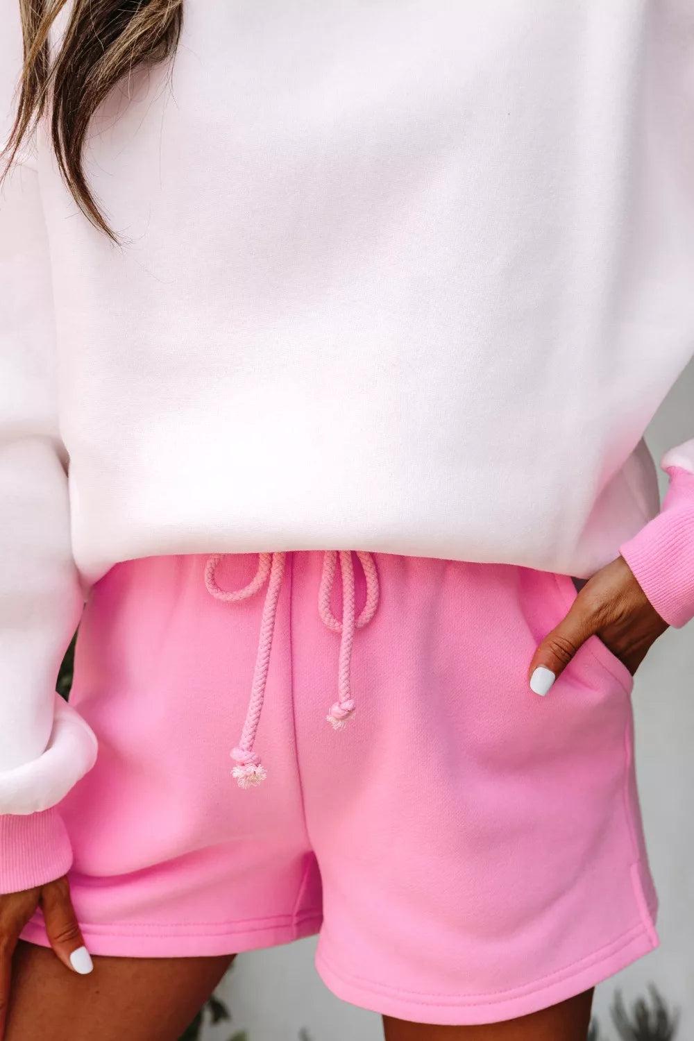 Close-up of drawstring elastic waist on pink shorts set