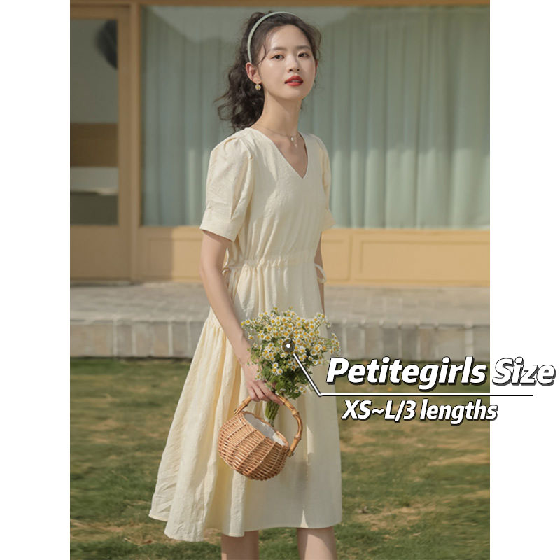 Petite Girls French Tea Break dress features a V-neck, drawstring-style neckline, elastic waist, commuting and office-style skirt silhouette, short sleeve, pleated midi-length skirt, solid-colored pattern,